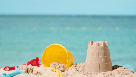 Summer-Holiday-Concept-Making-Sandcastle-On-Sandy-Beach-Against-Sea-Background-2