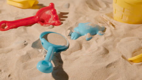 Summer-Holiday-Concept-Of-Children-Bucket-Spade-Toys-Beach-On-Sand-Background