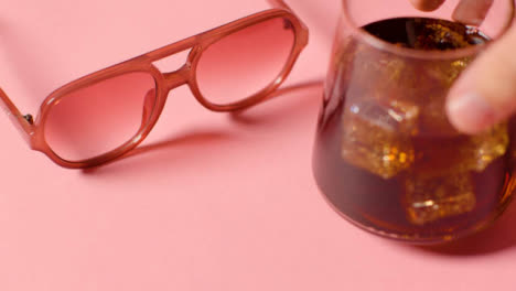 Summer-Holiday-Concept-Of-Sunglasses-And-Cold-Drink-On-Pink-Background-4