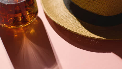 Summer-Holiday-Concept-Of-Sun-Hat-Cold-Drink-On-Pink-Background-1