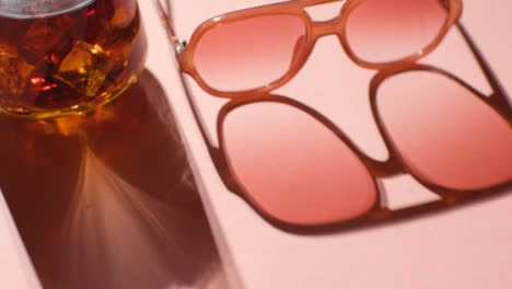 Summer-Holiday-Concept-Of-Sunglasses-Cold-Drink-On-Pink-Background-With-Shadow-2