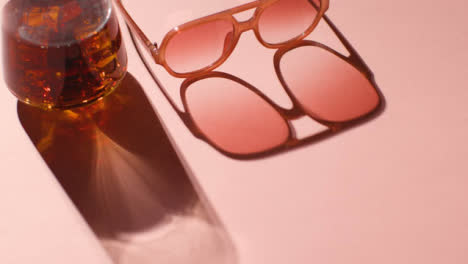 Summer-Holiday-Concept-Of-Sunglasses-Cold-Drink-On-Pink-Background-With-Shadow-4