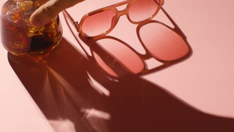 Summer-Holiday-Concept-Of-Sunglasses-Cold-Drink-On-Pink-Background-With-Shadow-6