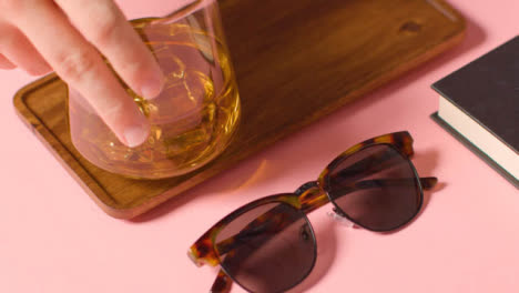 Summer-Holiday-Concept-Of-Sunglasses-Cold-Drink-Book-Tray-On-Pink-Background-1