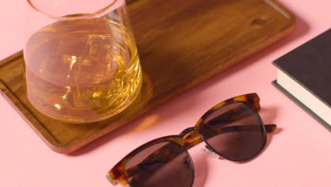 Summer-Holiday-Concept-Of-Sunglasses-Cold-Drink-Book-Tray-On-Pink-Background-3