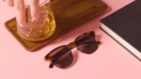 Summer-Holiday-Concept-Of-Sunglasses-Cold-Drink-Book-Tray-On-Pink-Background-4