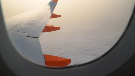 View-From-Plane-Window-Of-Clouds-On-Flight-To-Summer-Holiday-Vacation