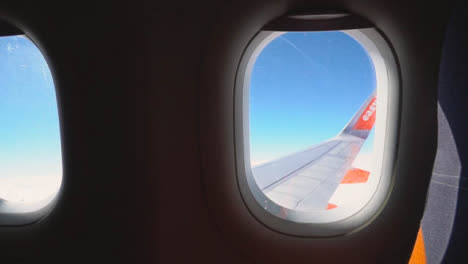 View-From-Plane-Window-Of-Blue-Sky-And-Clouds-On-Flight-To-Summer-Holiday-Vacation-3