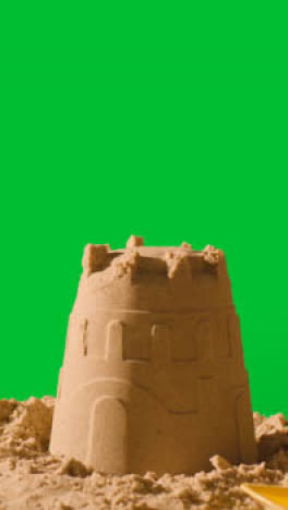 Vertical-Video-Summer-Holiday-Concept-Making-Sandcastle-On-Sandy-Beach-Against-Green-Screen-1