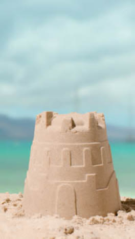 Vertical-Video-Summer-Holiday-Concept-Making-Sandcastle-On-Sandy-Beach-Against-Sea-Background