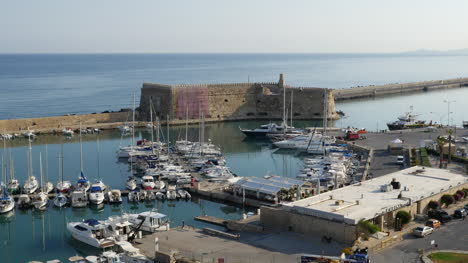 Greece-Crete-Heraklion-Harbor-With-Fort-In-Morning