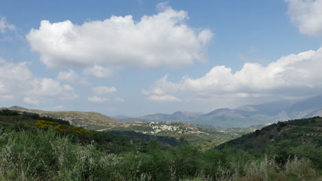 Grecia-Creta-Pueblo-Distante-Y-Nubes-En-El-Cielo-Azul
