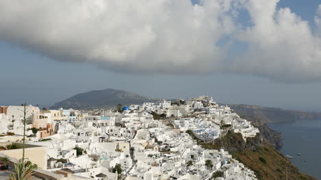 Greece-Santorini-Fira-City-Under-Cloud-With-Flying-Birds