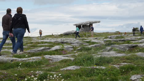 Ireland-County-Clare-Tourists-Walk-Towards-A-Dolmen-