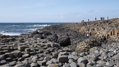 Northern-Ireland-Giants-Causeway-Hexagonal-Stones-And-Tourists-In-Distance