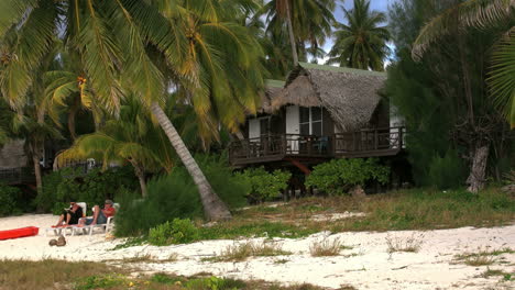 Aitutaki-Lodge-With-People-On-Beach