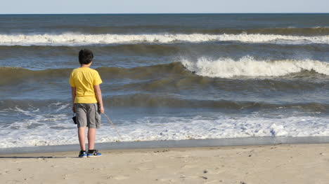Virginia-Boy-Pokes-At-Waves-With-Stick