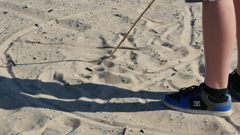 Virginia-Boy-Uses-Stick-To-Draw-In-Sand