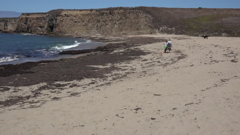 California-Santa-Cruz-People-On-Beach-With-Cliffs-Beyond