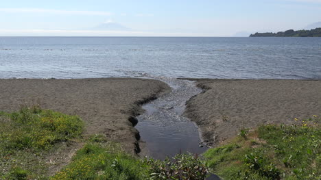 Chile-Steam-Enters-Lake-With-Osorno-In-Distance-Zoom-In