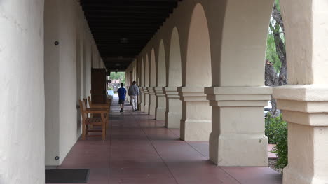 California-Solvang-Mission-Santa-Ines-People-Walking-Down-Colonnade