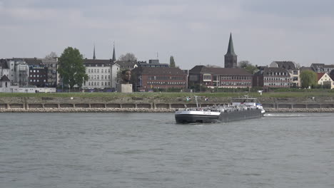Germany-Duisburg-Barge-Turns-By-Church-Zoom-In
