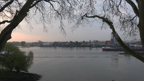 Netherlands-Barges-Pass-On-Lek-Distributary-Of-The-Rhine-At-Dawn-Time-Lapse