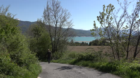 France-Man-Walking-Down-Road-Near-Lac-Serre-Poncon