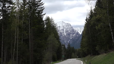 Austria-Dolomite-peak-and-road-through-forest