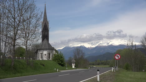 Austria-cars-and-motorcycle-on-highway-by-church-near-Kamering