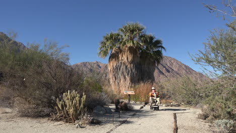 California-man-on-dirt-path-with-scooter-in-Anza-Borrego