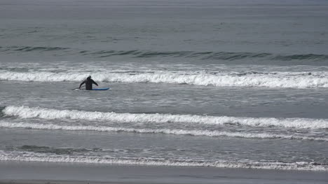 California-man-sits-on-paddle-board-in-water
