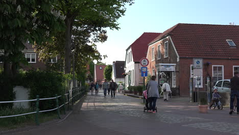 Germany-Greetsiel-mother-and-children-walking-in-street