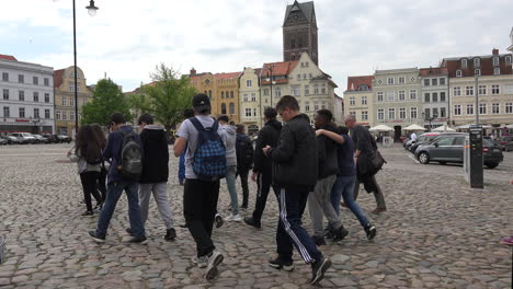 Germany-Wismar-tourists-walk-by