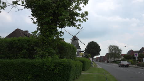 Germany-windmill-in-town-by-road-zoom-in