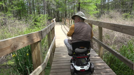 Louisiana-man-on-scooter-stops-to-look-from-boardwalk