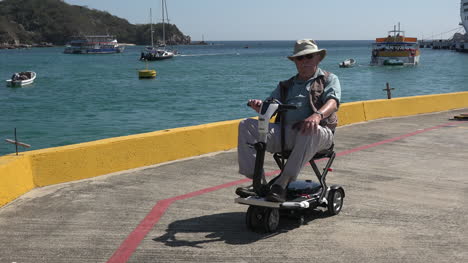 Mexico-Huatulco-man-rides-scooter-on-walkway