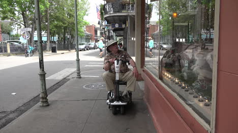 New-Orleans-man-on-scooter-window-shopping