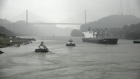 Panama-cargo-ship-and-tug-boats-in-canal