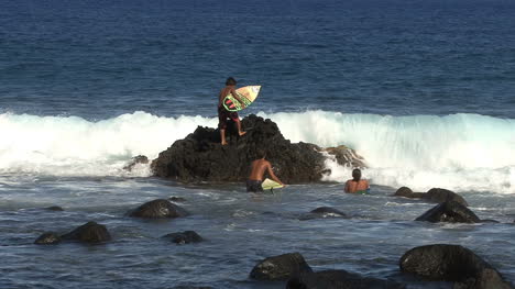 Hawaii-young-surfers-on-rocks-with-wave