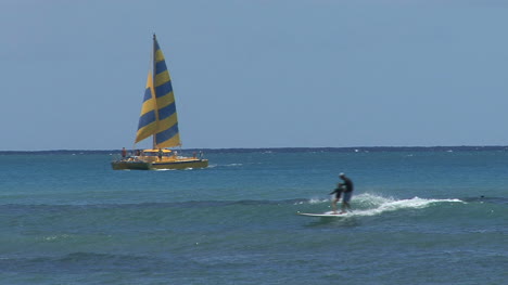 Waikiki-surfers-and-sail-boat-at-sea