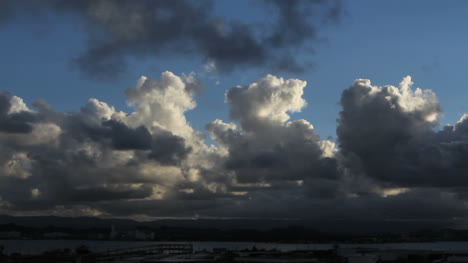 Cumulus-clouds-rise-into-a-blue-sky