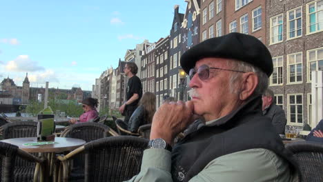 Netherlands-Amsterdam-houses-by-water-man-in-beret