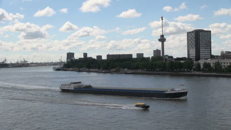 Netherlands-Rotterdam-boat-passes-barge-in-front-of-Euromast