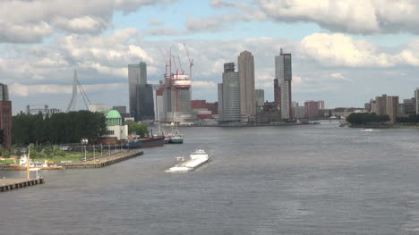 Netherlands-Rotterdam-skyscrapers-behind-white-barge