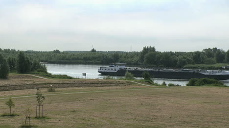 Netherlands-Oude-Maas-barge-navigates-narrow-waterway