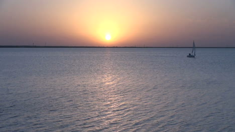 A-sailboat-sunset-on-a-peaceful-lake-s4
