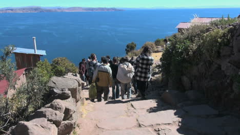 Peru-Taquile-tourists-descend-steps-toward-lake-24