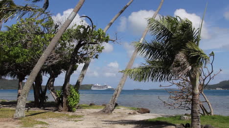 Bora-Bora-trees-frame-a-cruise-ship-anchored-in-the-lagoon