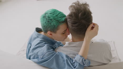 Back-View-Of-A-Loving-Woman-Tenderly-Caressing-Her-Boyfriend's-Head-While-Sitting-Together-On-A-Carpet-At-Home